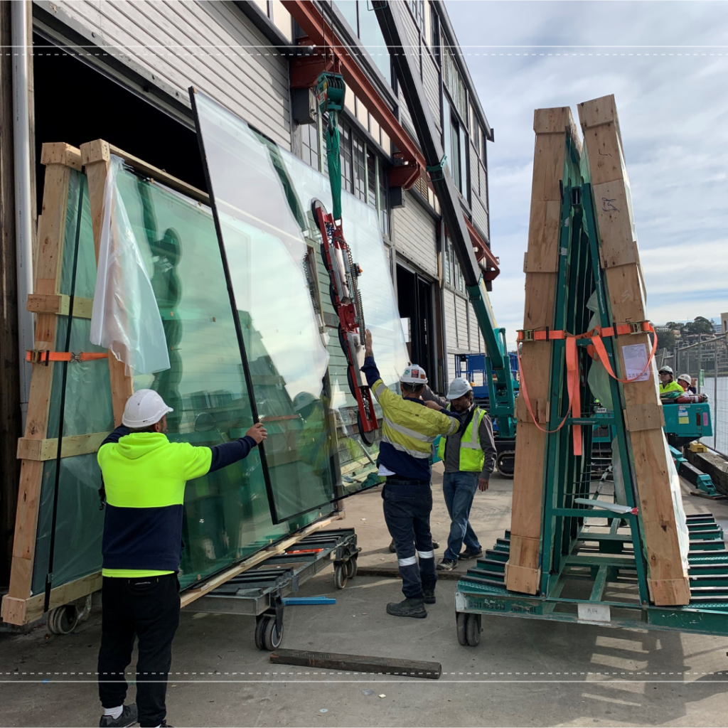 Workers fitting glass sliding doors